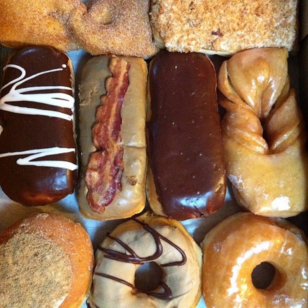 Nord&#146;s Bakery
2118 S. Preston St.
Nord&#146;s Bakery is a Louisville classic. The bakery has reliably served the Schnitzelburg for many years, and continues to make fresh donuts that you might have to line up outside the shop to get. Early birds get the donut. 
Featured in the photo are a selection of Nord&#146;s donuts, including chocolate, creme-filled, cinnamon twist, and a maple-flavored donut with a strip of bacon across the top.
