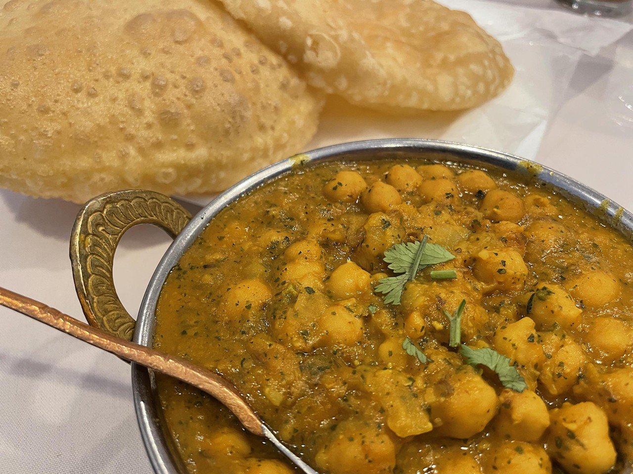 Shalimar Restaurant
1850 S. Hurstbourne Pkwy
Chana masala ($10.95), one of my favorite Indian entrees, is an iconic chickpea-based dish from Northern India. Shalimar’s version was a bowl of long-simmered, soft chickpeas in a thick sauce infused with garlic and ginger flavors and Indian spices. The medium-hot option wasn’t as spicy as I might have liked, but it was warm enough to keep me happy. Chana masala traditionally comes with puri (puffy pillows of deep-fried wheatbread), but here I had to order it a la carte.