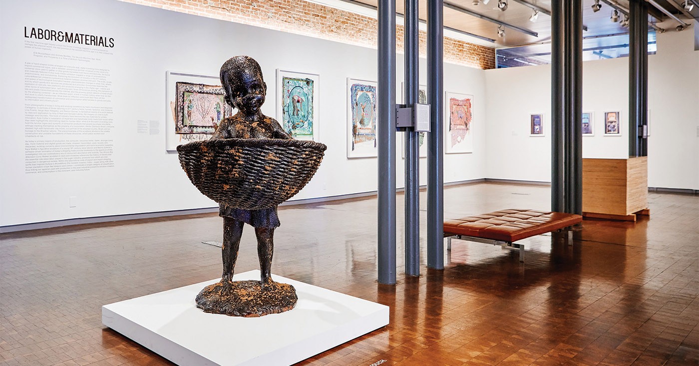 At 21c Museum Hotel:  &#145;African Boy Attendant Curio with Molasses and Brown Sugar,&#146; from &#145;The Marvelous Sugar Baby&#146; by Kara Walker. Installation at the old Domino Sugar factory Warehouse (front basket), 2014. Cast pigmented polyester resin with polyurethane coating with molasses and brown sugar.  |  Courtesy of 21c Museum Hotels.