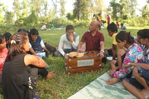 Rai (in white) sitting next to his teacher in the Pathri camp.