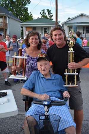 George Hauck, who passed away in 2021, takes a photo with Dainty champions in 2013. - Schnitzelburg.org