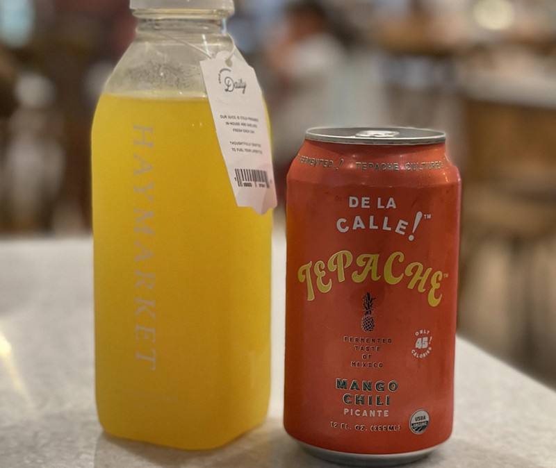 Haymarket’s own coffee shop is available, but the store also offers a variety of unusual drinks like this house-made cold-pressed turmeric ginger lemonade and a can of De La Calle Tepache mango chili picante. - Robin Garr