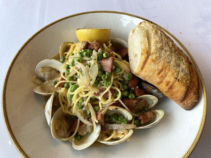 Got carbs? Tiny littleneck clams in the shell and spicy Portuguese linguiça sausage meet and mingle in this hearty spaghetti con vongole pasta dish with bread on the side at Osteria. - Robin Garr